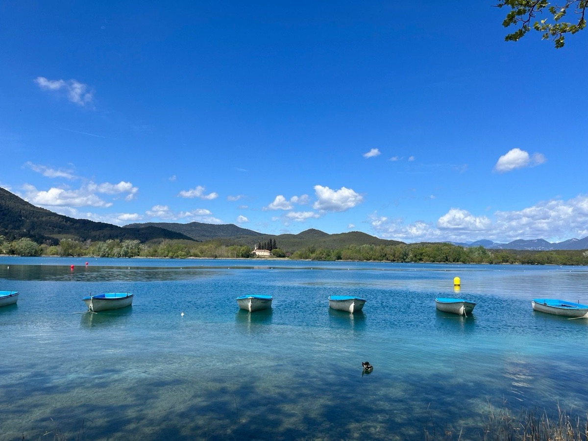 Blue boats on the clear water of Lake Banyoles on the Day 4 route