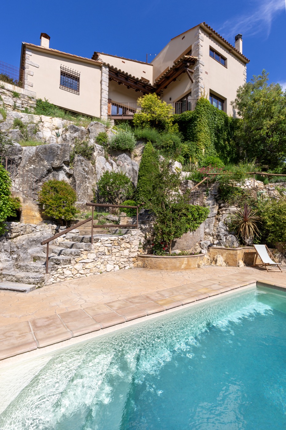 Can Martinoy above its private pool, terraced stone gardens climbing to the house