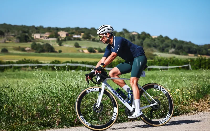 Emilio E. riding a road bike through green fields